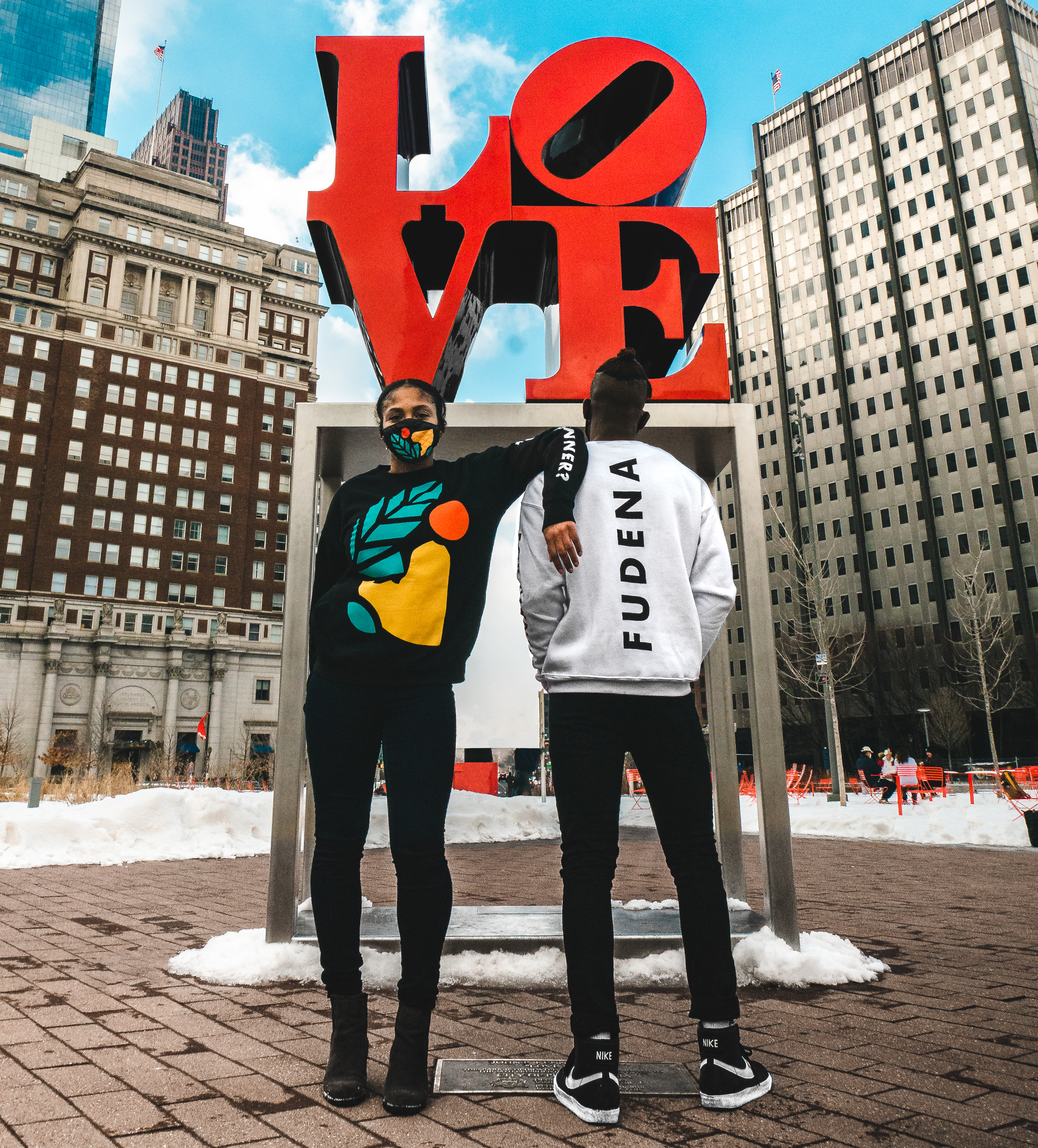 Photo of 2 models in Fudena swag in front of the Philly LOVE statue