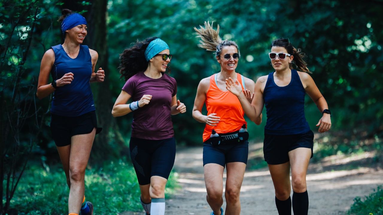 Four women running on a trail.