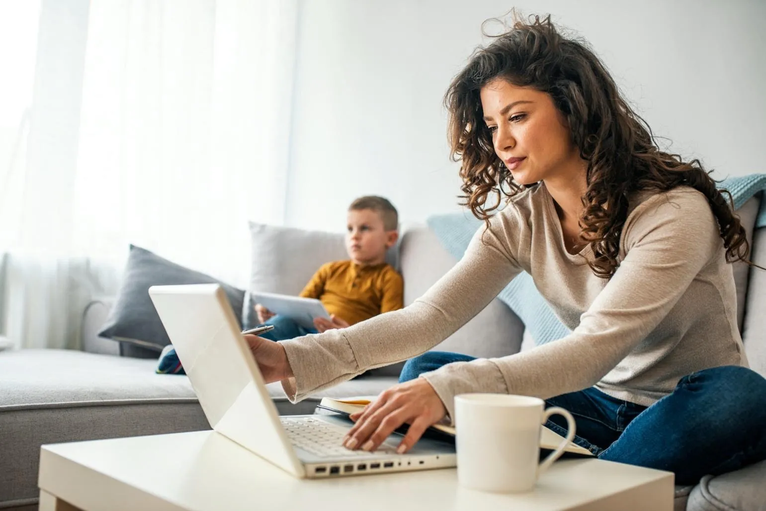 image of mother multi-tasking with children and work