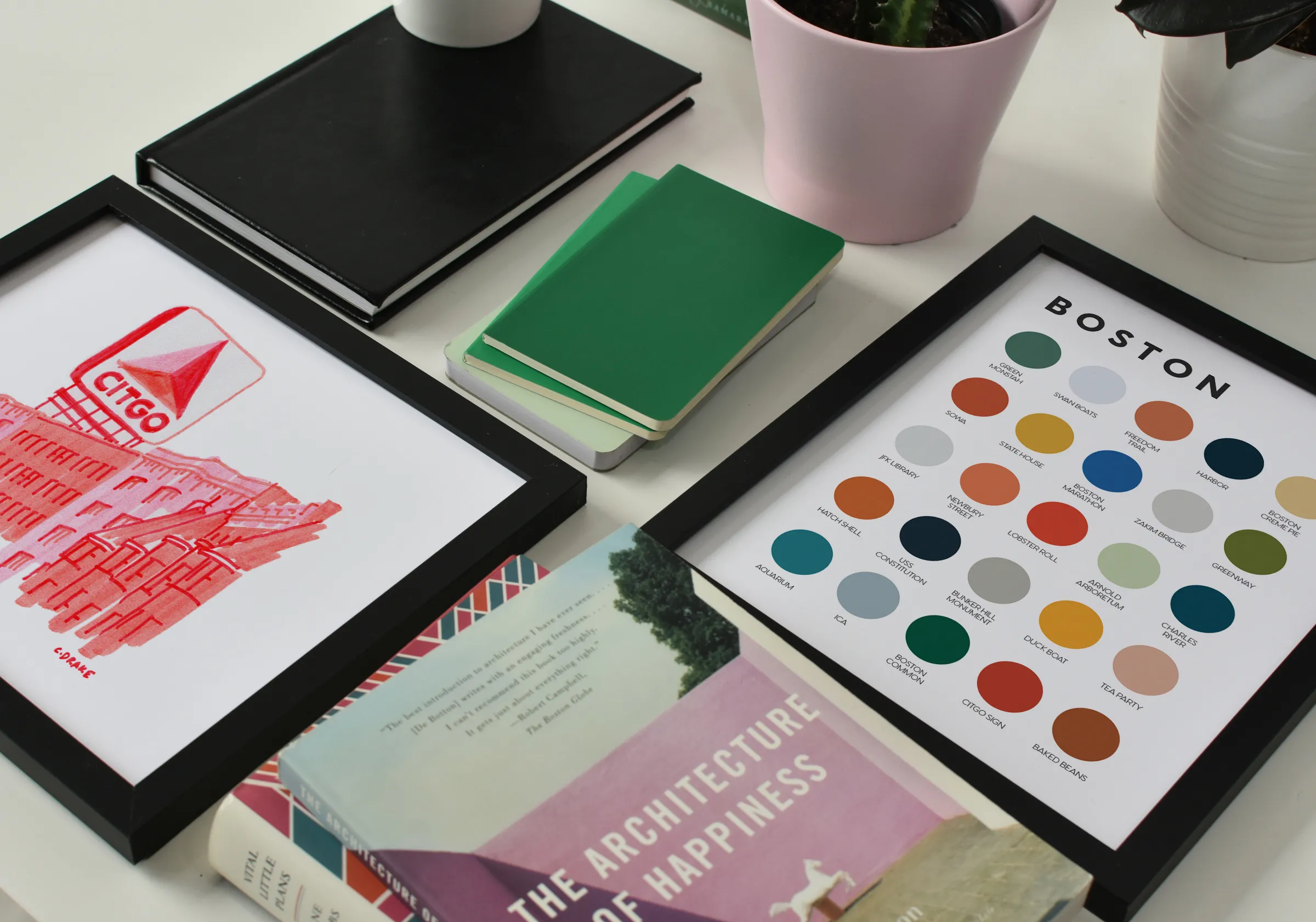 Photo of framed artwork, books, and plants