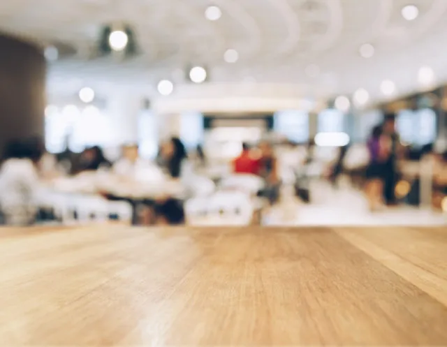 Table top Counter with Blurred People and Restaurant Shop interior background