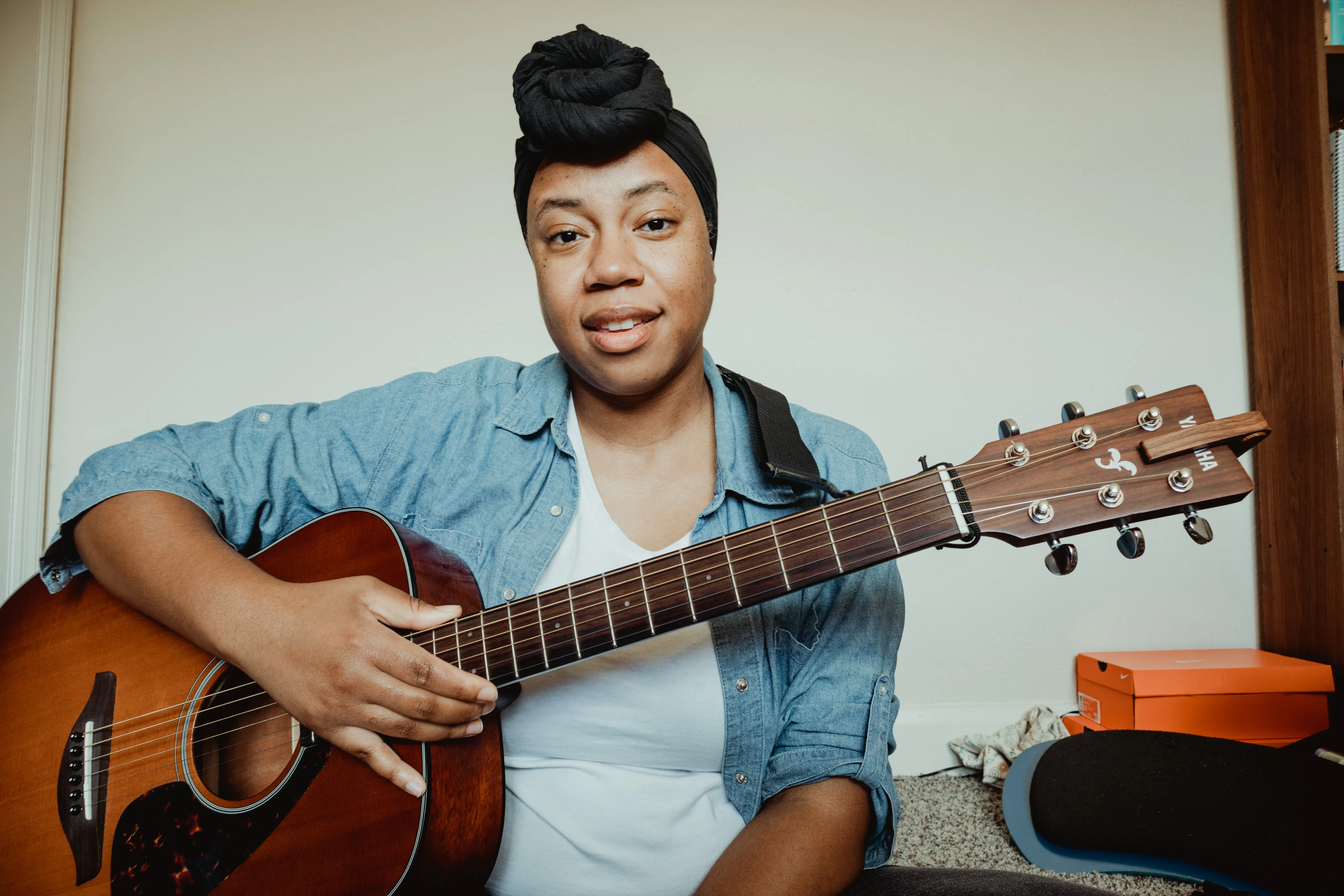 black woman holding a guitar