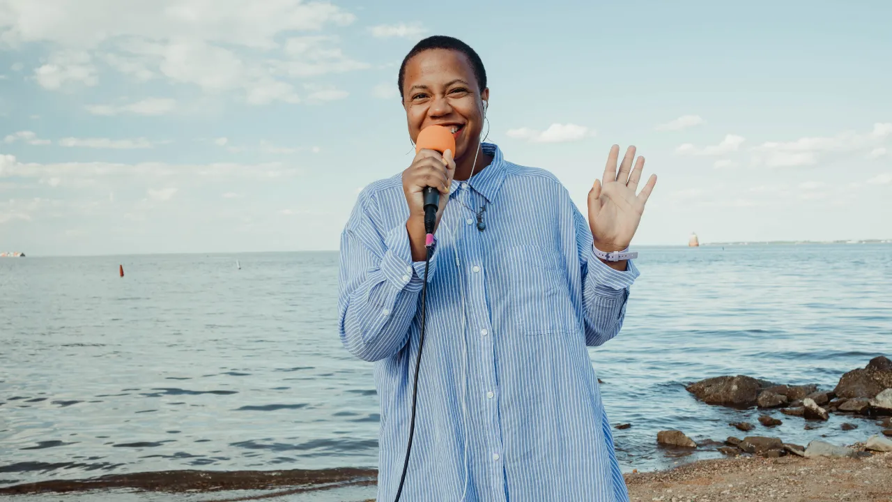 Black woman singing on the beach