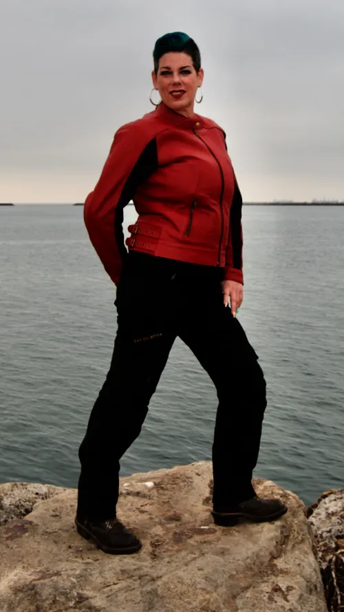 Image of model, Brin wearing a size 16 Phoenix Leather Jacket and size 12 Raven Pants
