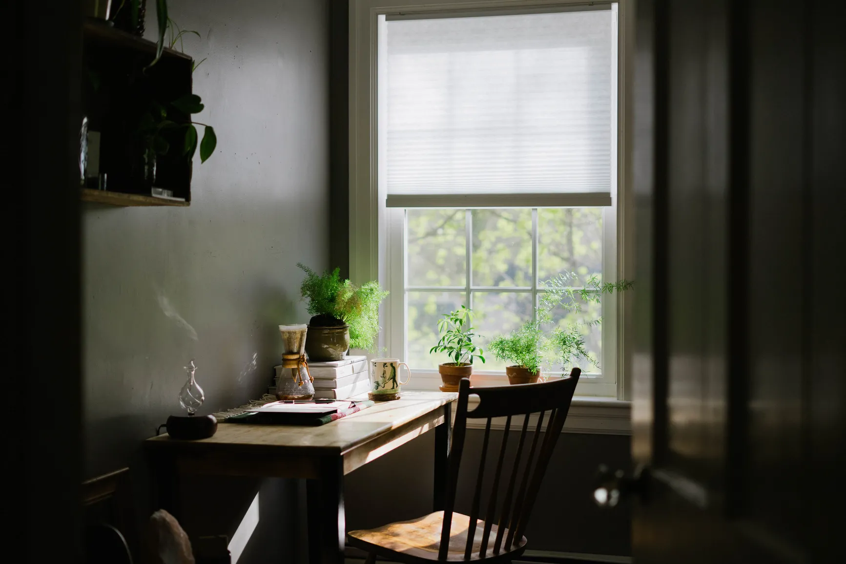 dark writing nook with table by a window