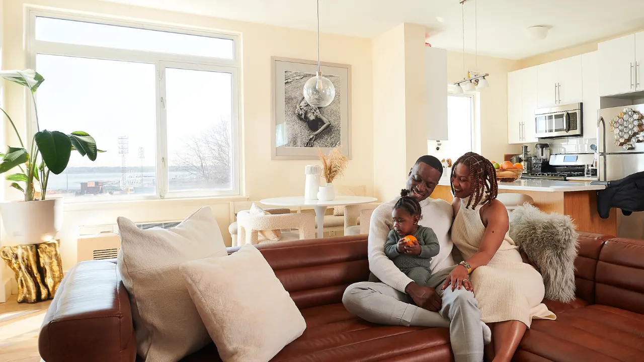 Black millennial family sitting on the couch 