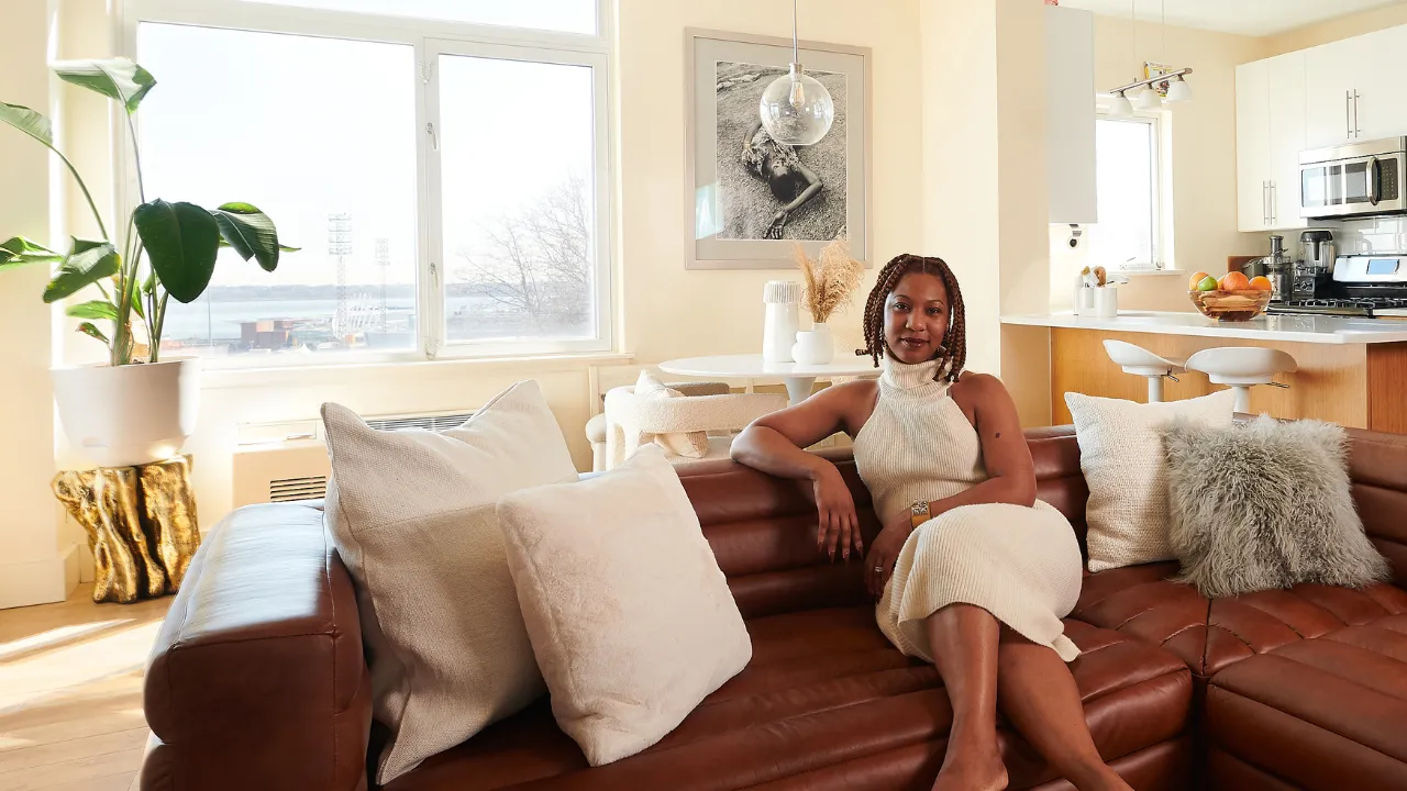 Black woman sitting on her couch